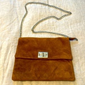 Tan, suede cross body on a silver 40” chain.